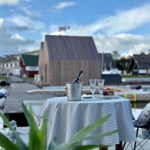 Round beige tablecloth with blue lines, made from recycled linen blend, sustainable Nordic design
