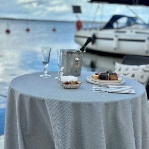 Round beige tablecloth with blue stripes, made from recycled linen blend, sustainable Nordic design
