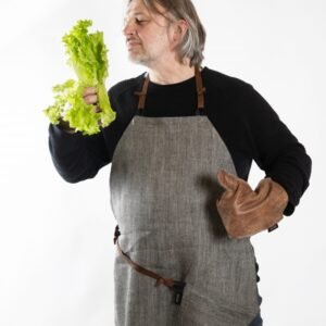 KOOSdisain linen apron with black and grey herringbone pattern and repurposed leather details, handmade Nordic-style kitchen and studio apron