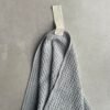 Large grey waffle sauna towel by KOOSdisain, linen–cotton blend with white fishbone pattern and white cotton hanger