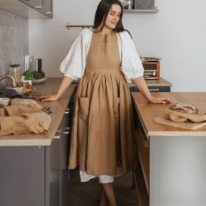 NUSS Linen Retro Apron in natural 100% linen with pockets and adjustable straps, handmade in Latvia