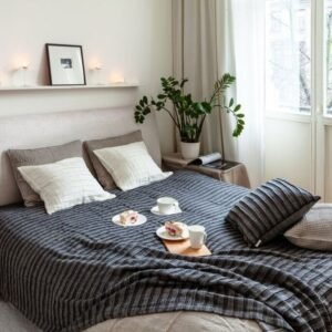 Linen bedcover 270×270 cm by KOOSdisain in black and gray, corrugated linen–cotton fabric on a double bed